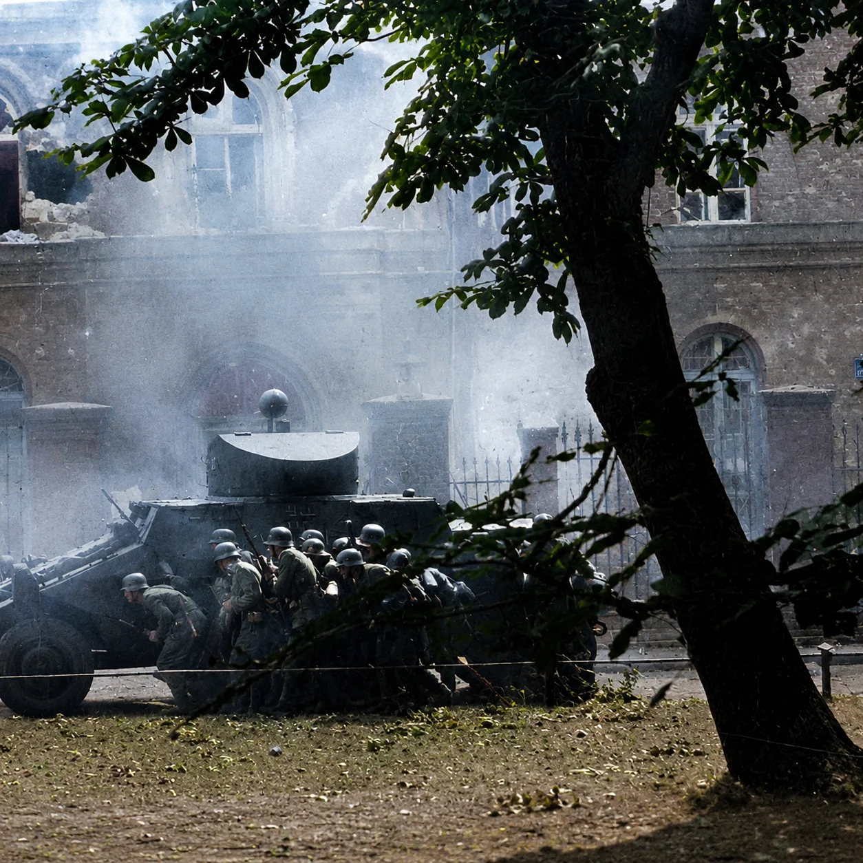 German SS soldiers advancing on the Post Office in Danzig under cover of an ADGZ armored vehicle